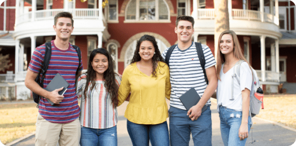 Five students in front of main hall