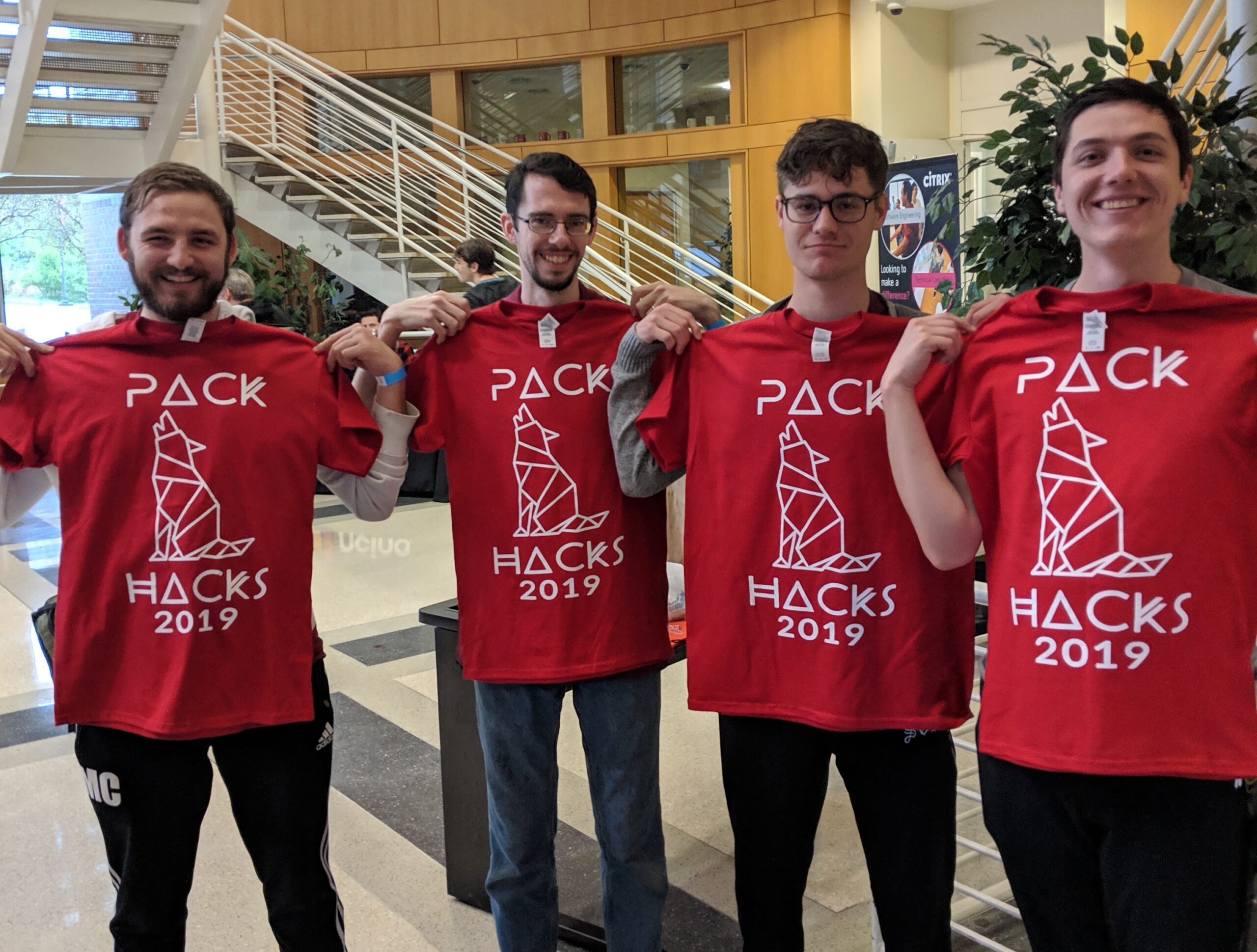 Students holding winning T-shirt prize