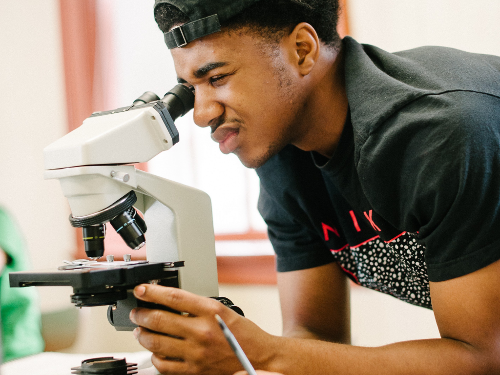 Student looking through microscope