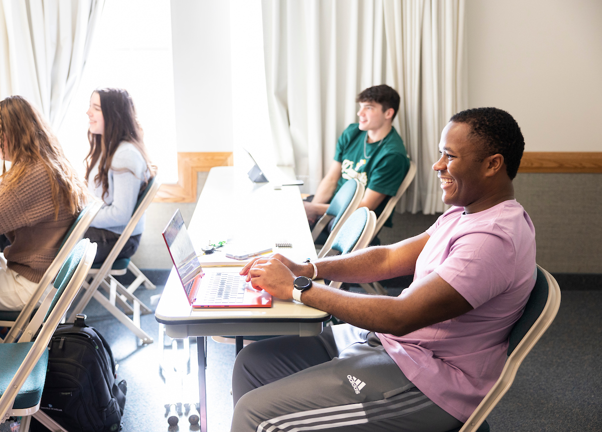 Institute student with a laptop in class