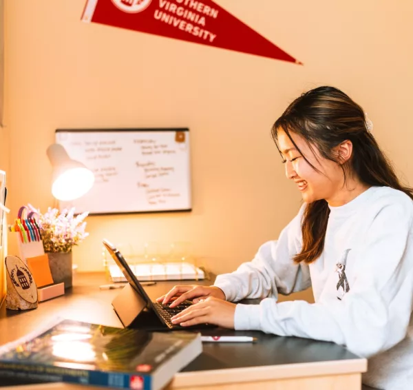 Student studying in dorm room.