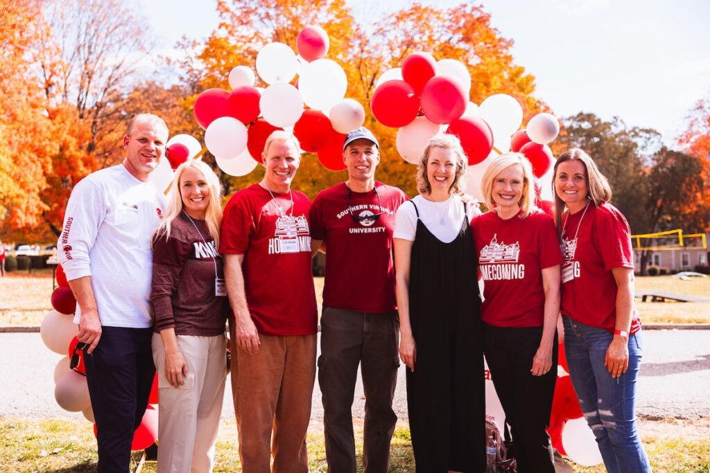 Alumni posing for a photo at Homecoming