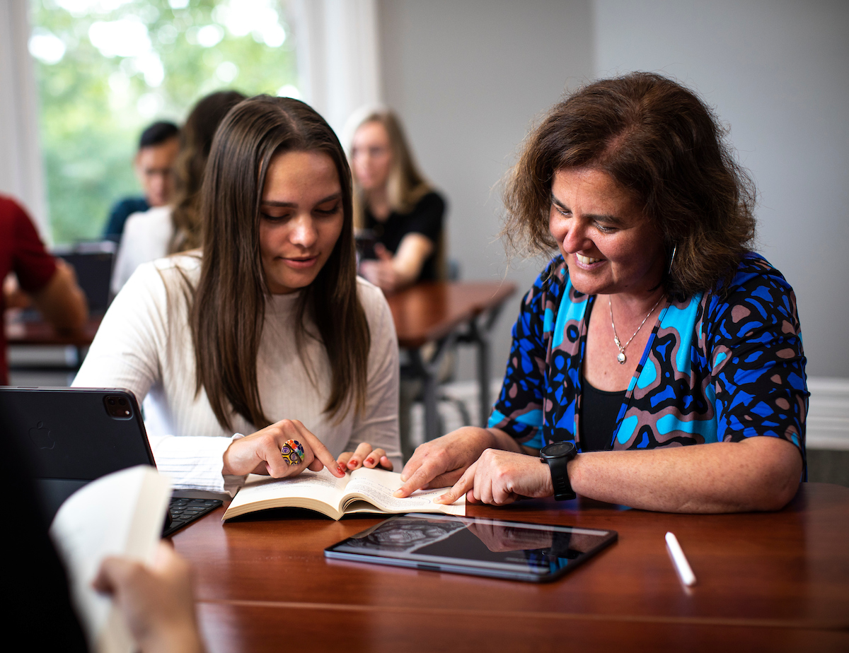 Professor helping a student in the classroom