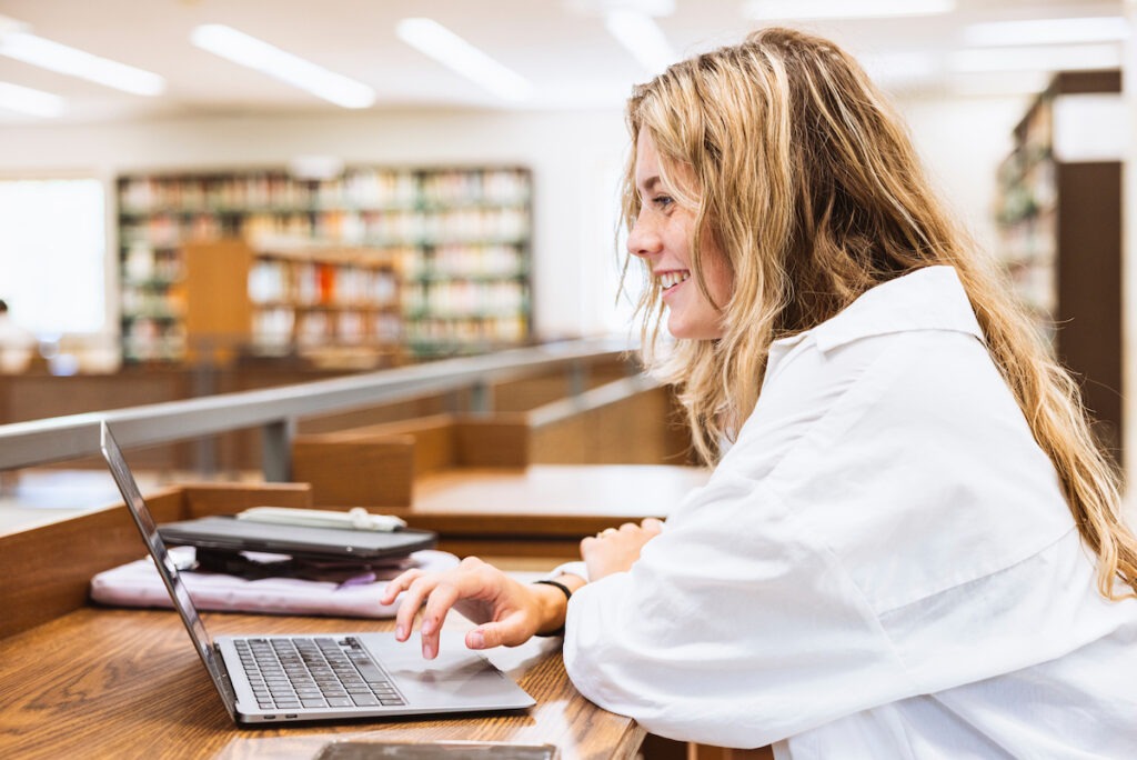 Student using laptop in library