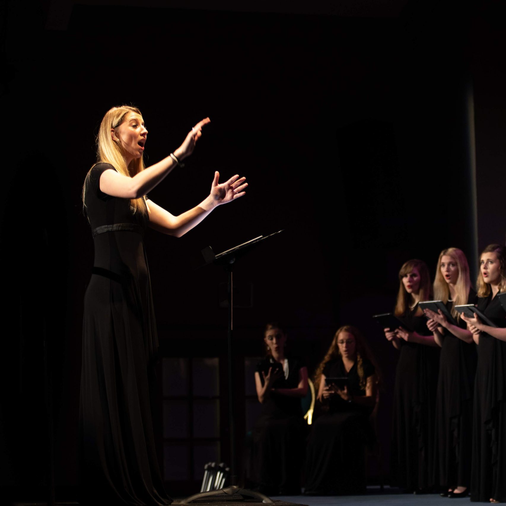 Mckenzie Kitchen conducting choir